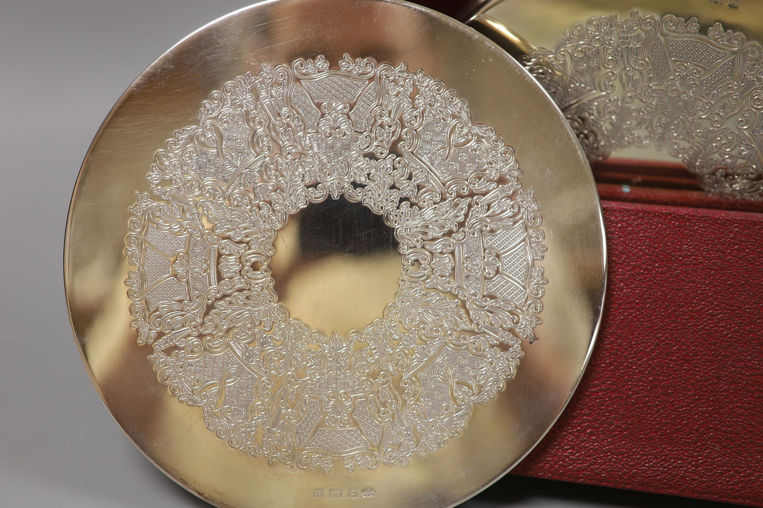 A set of six circular silver-mounted table mats